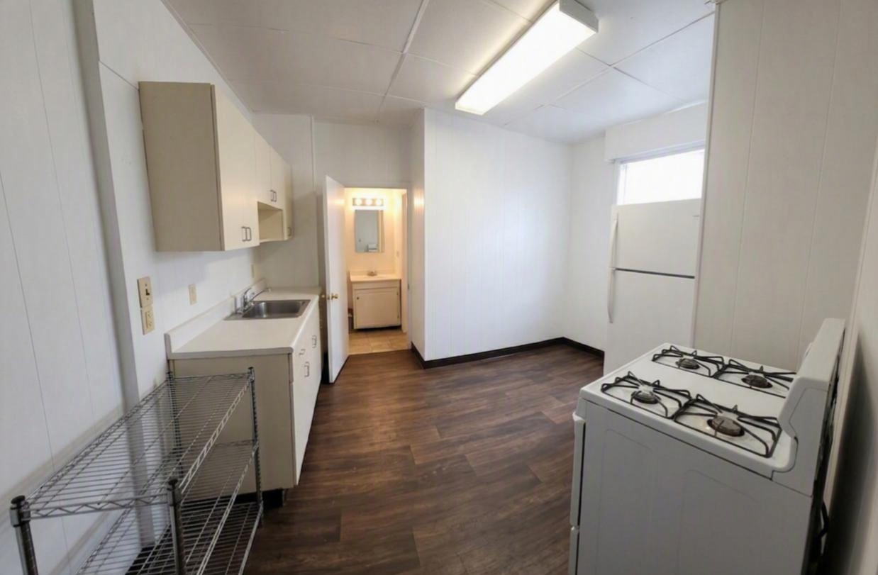 306 Woodward Unit 3 kitchen with gas stove, refrigerator, and space for a small dining setup