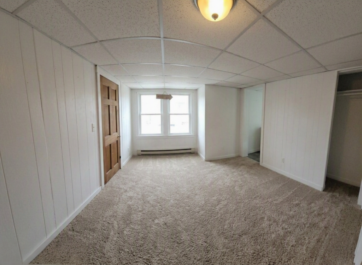 306 Woodward Unit 3 living area with carpet, bright windows, and view toward the hallway