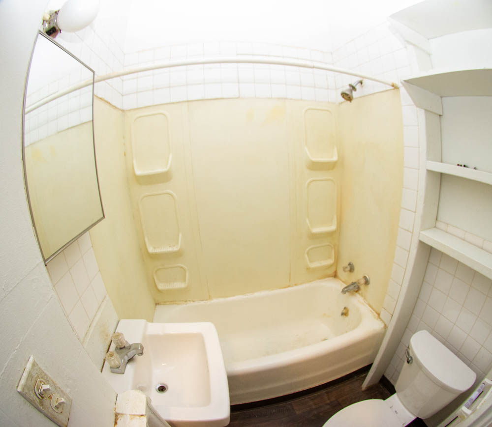 312 Unit 8 bathroom with tub shower, sink, toilet, and built-in shelving